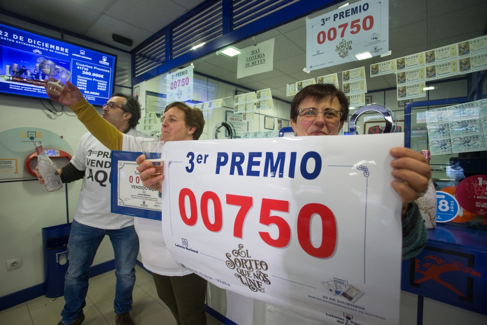 Los dueños del establecimento de loterÁ­a de Rua da Pravia, 18 de Vilalba, posan con el número 00750, premiado con el Tercer Premio del Sorteo Extraordinario de LoterÁ­a de Navidad 2019, el cual vendieron en su establecimiento, en Lugo /Galicia (España  / CARLOS CASTRO   EUROPA PRESS