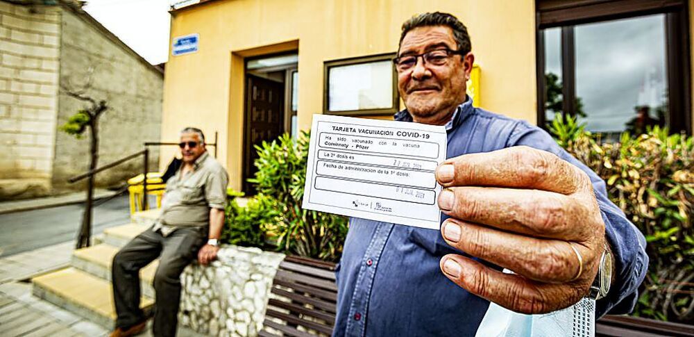 Un vecino de Adalia con la cartilla de la primera dosis en la mano. 